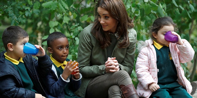 Catherine, Duchess of Cambridge sits on a log with children during a visit to Sayers Croft Forest School and Wildlife Garden on Oct. 2, 2018, in London, England. (Photo by Peter Nicholls - WPA Pool/Getty Images)