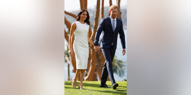 Prince Harry and Meghan Markle hold hands during their visit to Admiralty House in Sydney, Australia on October 16, 2018.