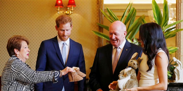 Prince Harry and Meghan Markle receive gifts from the Governor General of Australia, Sir Peter Cosgrove, and his wife, Lady Cosgrove, at the Admiralty House in Sydney, Australia on October 16, 2018.