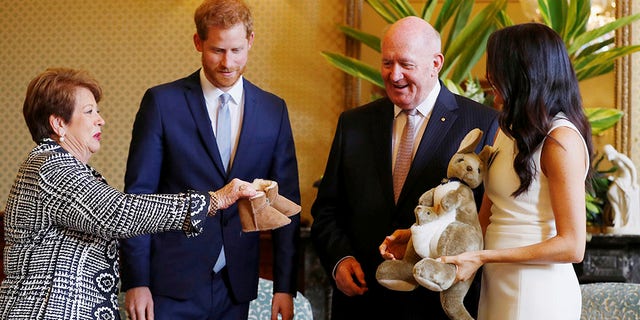 Prince Harry and Meghan Markle receive gifts from Australia's Governor General Sir Peter Cosgrove and his wife Lady Cosgrove at Admiralty House in Sydney, Australia on Oct. 16, 2018.