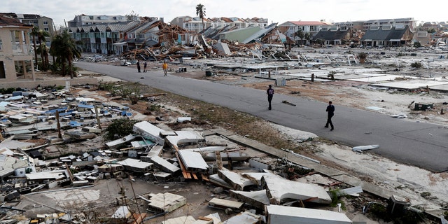 Rescue personnel search amidst debris in the aftermath of Hurricane Michael in Mexico Beach, Fla.