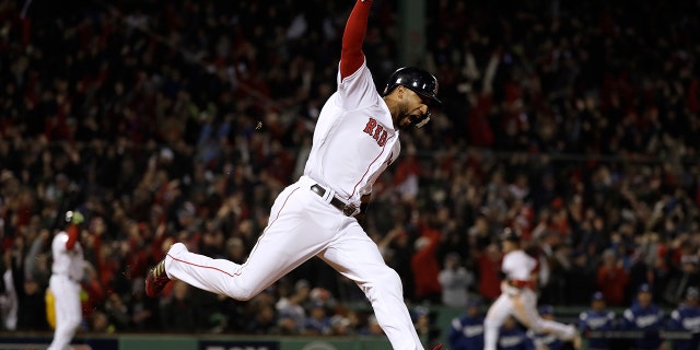 Boston Red Sox's Eduardo Nunez reacts as he runs the bases after hitting a three-run home run during the seventh inning of Game 1 of the World Series baseball game against the Los Angeles Dodgers on Tuesday.