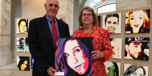 Anne Marie and Jim Zanfagna with portrait of their daughter Jacqueline