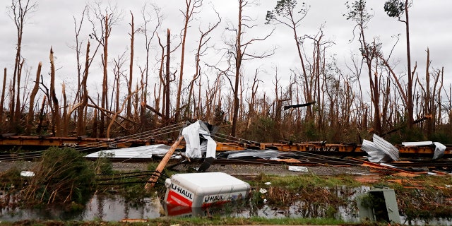 Shredded trees, derailed train cars and a sunken trailer are seen in the aftermath of Hurricane Michael in Panama City, Fla., Wednesday, Oct. 10, 2018. (AP Photo/Gerald Herbert)