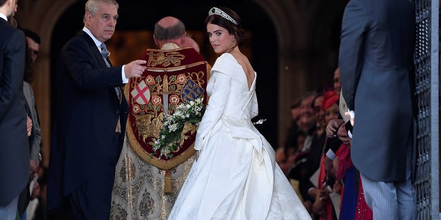 Britain's Princess Eugenie enters St George's Chapel with her father Prince Andrew, Duke of York, for her wedding to Jack Brooksbank in Windsor Castle, Windsor, Britain October 12, 2018. REUTERS/Toby Melville - RC11C0AD5490