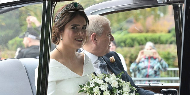 Princess Eugenie of York, left, arrives with her father Prince Andrew, Duke of York for her wedding with Jack Brooksbank in St George's Chapel, Windsor Castle, near London, England, Friday, Oct 12, 2018.