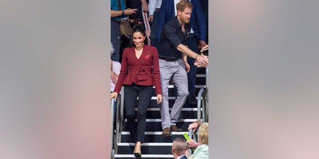 Britain's Prince Harry and Meghan, Duchess of Sussex arrive to watch the wheelchair basketball final at The Invictus Games in Sydney, Australia, Saturday, Oct. 27, 2018. Prince Harry and his wife Meghan are on day twelve of their 16-day tour of Australia and the South Pacific.(AP Photo)