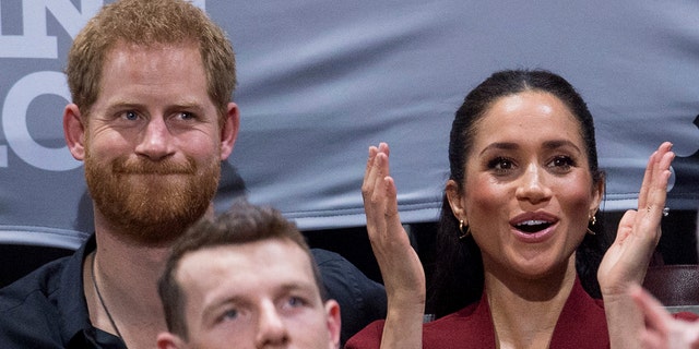 Britain's Prince Harry and Meghan, Duchess of Sussex applaud as they watch the wheelchair basketball final at The Invictus Games in Sydney, Australia, Saturday, Oct. 27, 2018. Prince Harry and his wife Meghan are on day twelve of their 16-day tour of Australia and the South Pacific. (AP Photo)