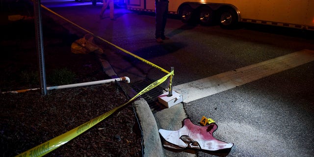 Blood-soaked evidence lies on Saxon Drive in the Vintage Place neighborhood of Florence, S.C., where several members of law enforcement were shot, one fatally, Oct. 3, 2018.