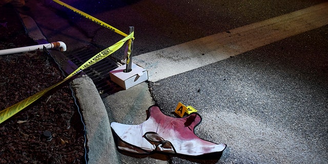 Blood-soaked evidence lies on Saxon Drive in the Vintage Place neighborhood where several members of law enforcement were shot, one fatally, Wednesday, Oct. 3, 2018, in Florence, S.C. (AP Photo/Sean Rayford)