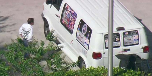 Authorities in Florida investigate a van believed to belong to the suspect