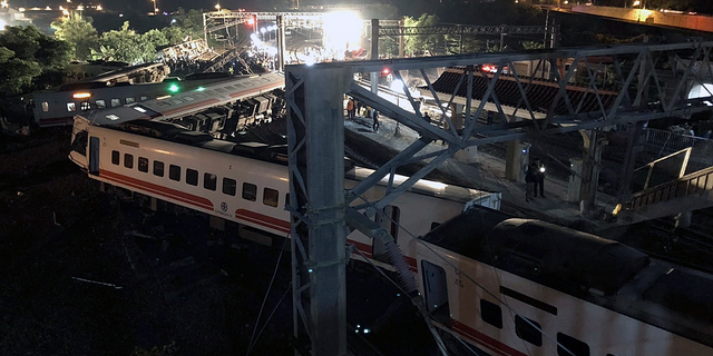 This photo released by Military News Agency shows a general view at the site of a train derailment in Lian in northern Taiwan on Sunday, Oct. 21 2018. The Puyuma express train was carrying more than 300 passengers toward Taitung, a city on Taiwan's southeast coast, when it went off the tracks on Sunday afternoon.