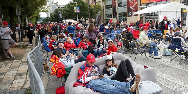 Kersten Buck, 25, and her fiance Clayton Dupree, 25, sit on an inflatable couch as they wait for a President Trump rally for Sen. Ted Cruz at the Toyota Center on Monday in Houston. (Godofredo A. Vasquez/Houston Chronicle via AP)