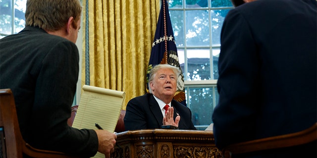 President Donald Trump speaking during an interview with The Associated Press in the Oval Office of the White House on Tuesday in Washington.