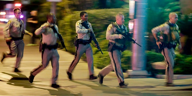 Police running toward the scene of the Las Vegas shooting as it happened one year ago.