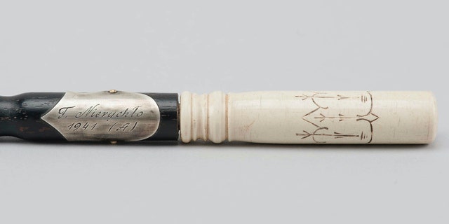 In this Oct. 24, 2018 photo publicly provided by the Museum of the former Nazi German death camp of Auschwitz Birkenau is seen the wood-and-ivory baton of Franciszek Nierychlo, Auschwitz prisoner and controversial organizer and first conductor of the inmates' orchestra, in Oswiecim, Poland. (Museum of the former Nazi German death camp of Auschwitz Birkenau/Marcin Inglot via AP)
