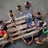 Central American migrants trying to reach the United States use a raft after climbing down from a bridge that connects Mexico and Guatemala in Ciudad Hidalgo, Mexico, on Oct. 20, 2018.