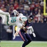 Miami Dolphins Mike Gesicki is upended by Houston Texans Kareem Jackson after a catch as free safety Tyrann Mathieu looks on during the first half of an NFL football game in Houston, Oct. 25, 2018. 