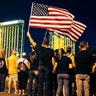 People form a human chain around the shuttered site of a country music festival where a gunman opened fire on the first anniversary of the mass shooting, in Las Vegas, Oct. 1, 2018.