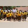 First lady Melania Trump walks with singing children as she visits the Nest Orphanage in Limuru, Kenya, Oct. 5, 2018.