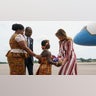 First lady Melania Trump accepts flowers from flower girl Lillian Naa Adai Sai, 8, as she receives flowers as she arrives at Kotoka International Airport in Accra, Ghana, Tuesday, Oct. 2, 2018.  (AP Photo/Carolyn Kaster)