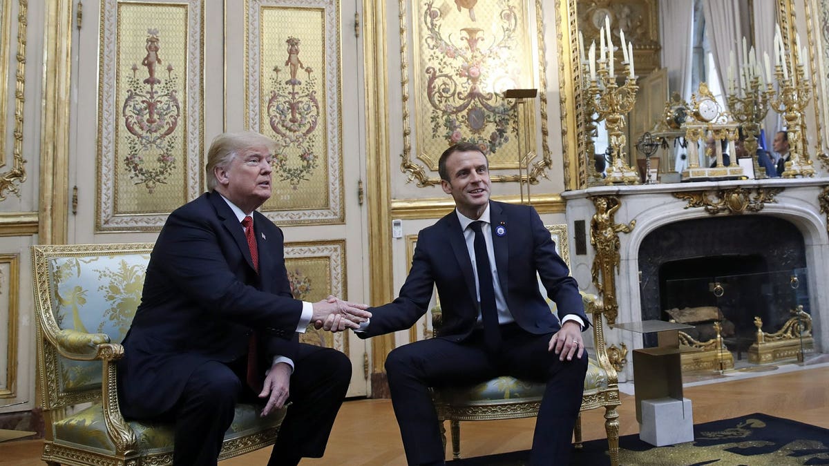 President Donald Trump shakes hands with French President Emmanuel Macron inside the Elysee Palace in Paris Saturday Nov. 10, 2018. Trump is joining other world leaders at centennial commemorations in Paris this weekend to mark the end of World War I.