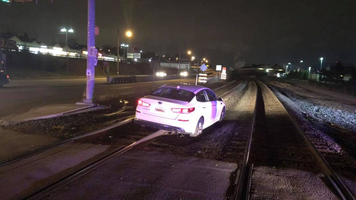 A woman says she followed her GPS, which led her to drive onto train tracks.