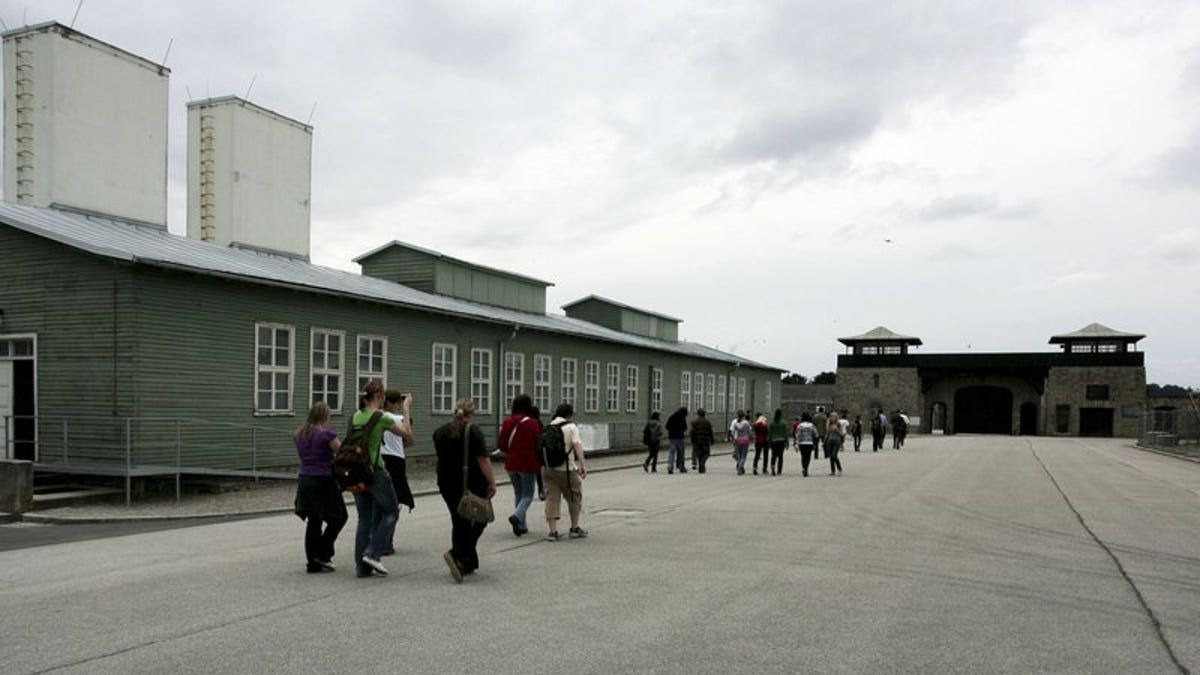 In this June 17, 2008 file photo, young people and participants of a conference of the Task Force for International Cooperation on Holocaust Education, Remembrance and Research visit the former Nazi concentration camp in Mauthausen, Austria. 