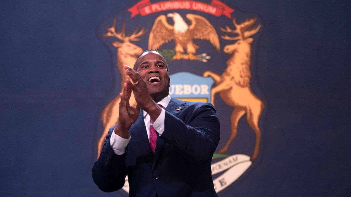 U.S. Senate candidate John James pumps up the crowd before his speech at a rally featuring GOP political candidates and Vice President Mike Pence.