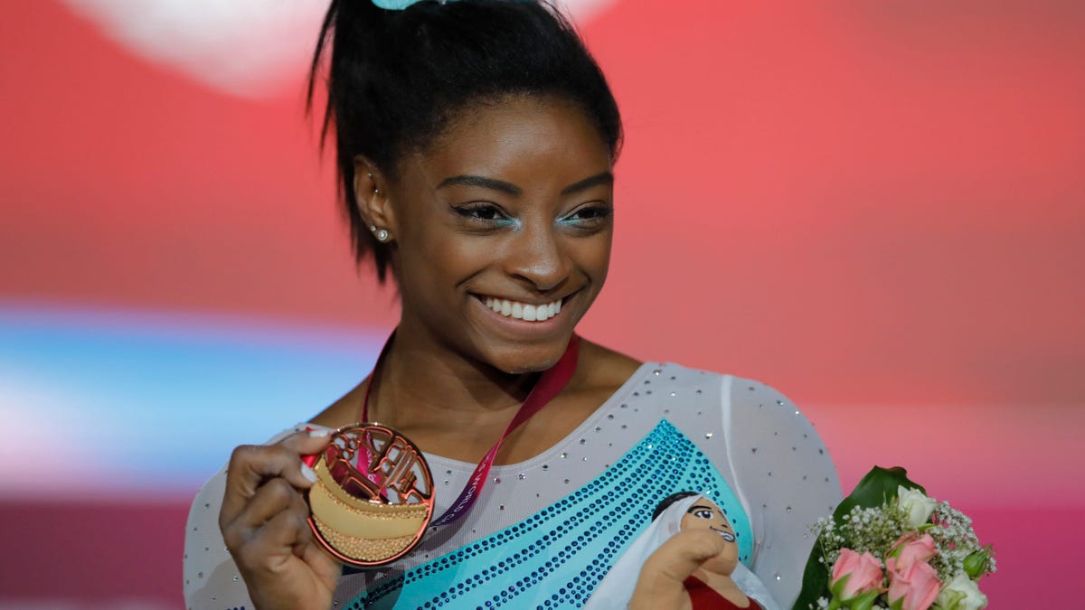Gold medallist and four-times All-Around world champion Simone Biles of the U.S., poses on the podium after the Women's All-Around Final of the Gymnastics World Championships at the Aspire Dome in Doha, Qatar, Thursday, Nov. 1, 2018. (AP Photo/Vadim Ghirda)