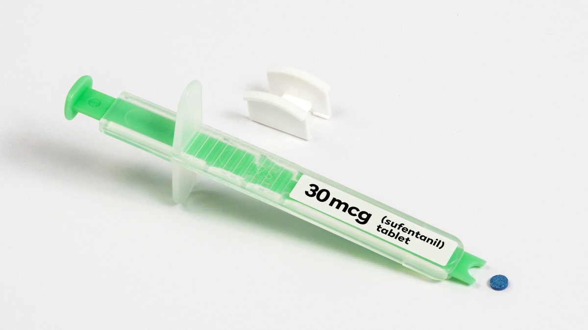 This undated image provided by AcelRx Pharmaceuticals shows the dispenser and a tablet for the company's medication Dsuvia.