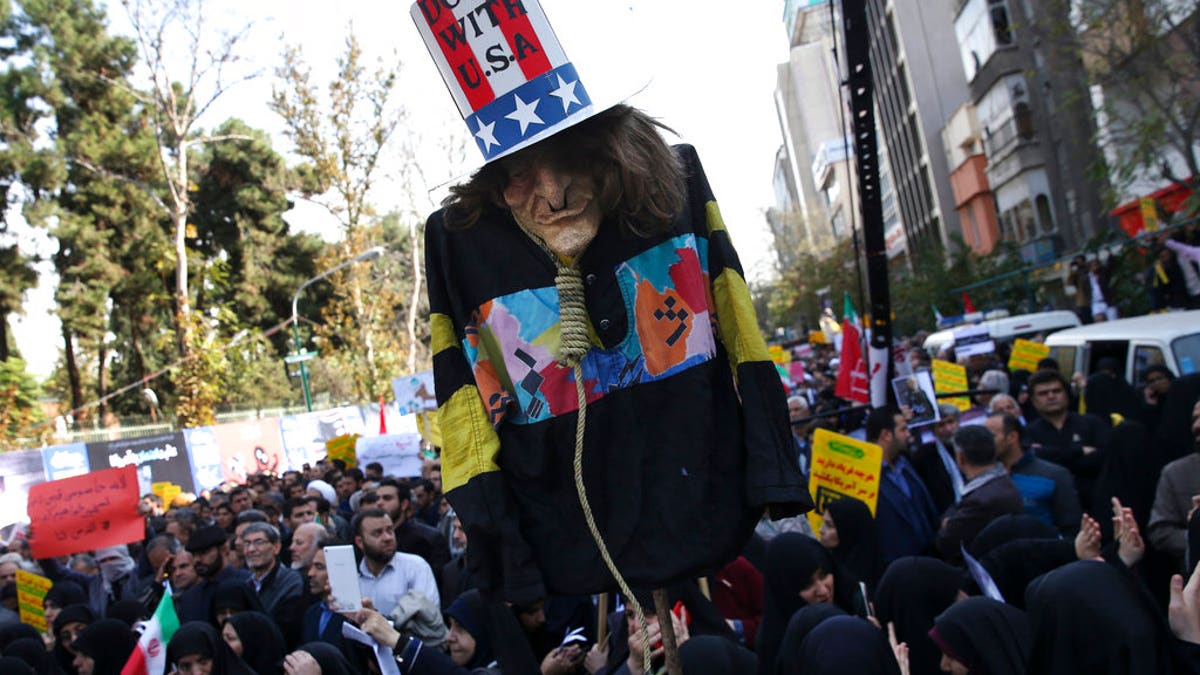 FILE: An effigy of U.S. government icon "Uncle Sam" is held up by demonstrators during a rally in front of the former U.S. Embassy in Tehran, Iran.