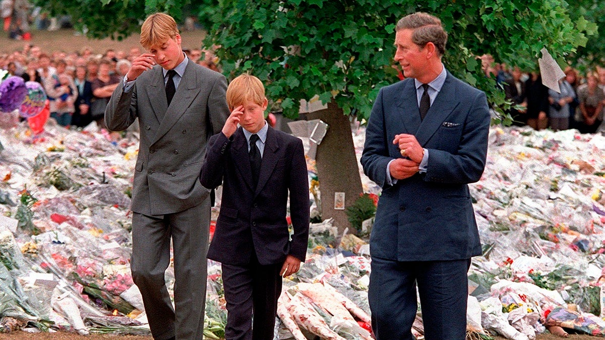 In this Friday, Sept. 5, 1997 file photo Britain's Prince Charles, right, accompanies his sons Prince William, left and Prince Harry after they arrived at Kensington Palace to view tributes left in memory of their mother Princess Diana in London. 
