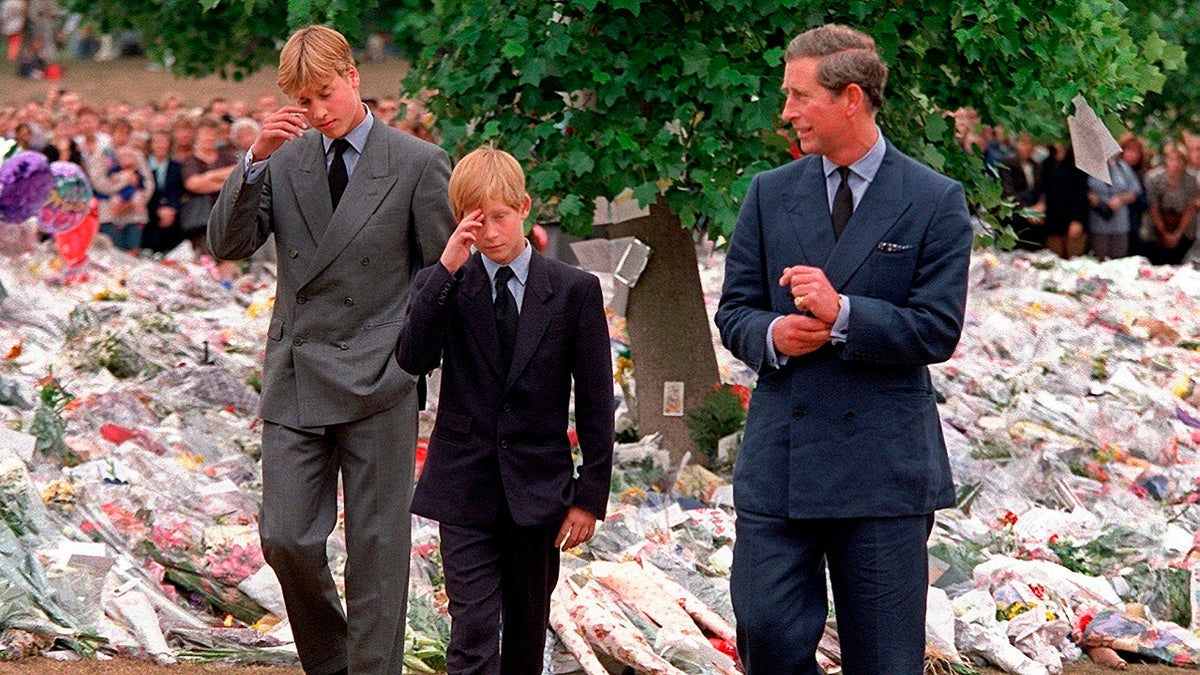 In this Friday, Sept. 5, 1997 file photo Britain's Prince Charles, right, accompanies his sons Prince William, left and Prince Harry after they arrived at Kensington Palace to view tributes left in memory of their mother Princess Diana in London.?