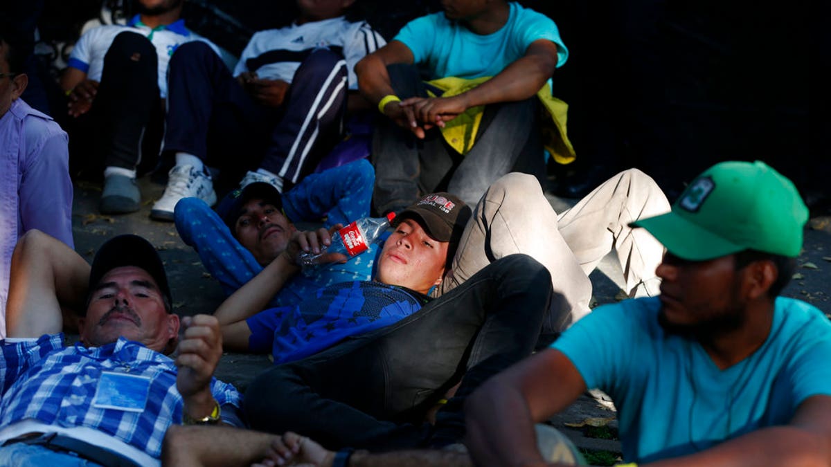 Members of the caravan which has stopped in Mexico City demanded buses Thursday to take them to the U.S. border, saying it is too cold and dangerous to continue walking and hitchhiking.
