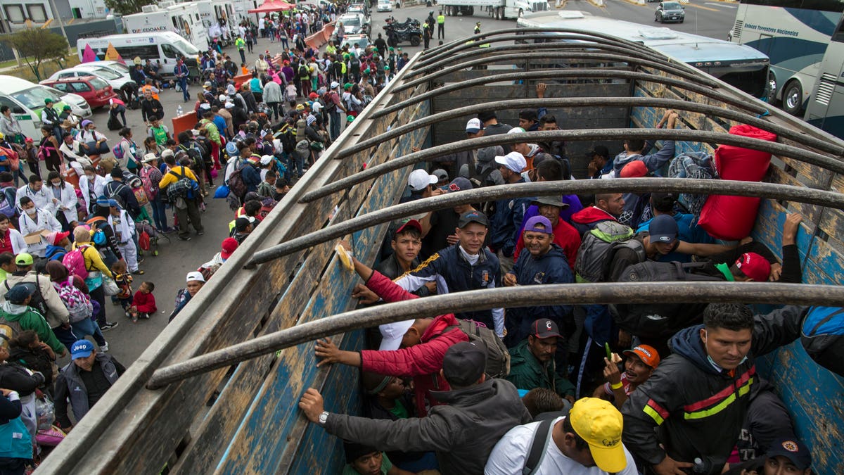 Central American migrants travel on a truck after hitching a ride in Tepotzotlan, Mexico, as they resume their journey north after leaving the temporary shelter in Mexico City. A small group of migrants have already reached the U.S. border. (AP Photo/Rodrigo Abd)