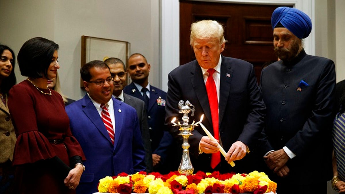 President Donald Trump participates in a Diwali ceremonial lighting of the Diya in the Roosevelt Room of the White House, Tuesday, Nov. 13, 2018, in Washington. (AP Photo/Evan Vucci)