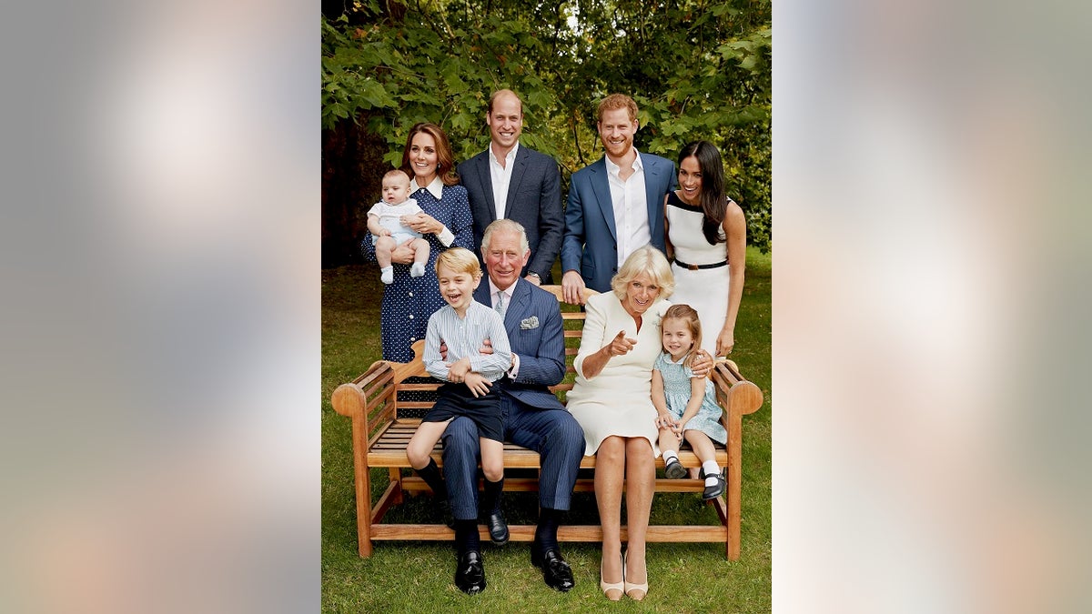 In this handout image provided by Clarence House and taken on Sept. 5, 2018, Britain's Prince Charles poses for an official portrait to mark his 70th Birthday in the gardens of Clarence House, with Camilla, Duchess of Cornwall, Prince William, Kate, Duchess of Cambridge, Prince George, Princess Charlotte, Prince Louis, Prince Harry and Meghan, Duchess of Sussex, in London, England.