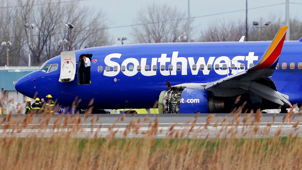 In this April 17, 2018, file photo a Southwest Airlines plane sits on the runway at the Philadelphia International Airport after it made an emergency landing in Philadelphia. (David Maialetti/The Philadelphia Inquirer via AP)