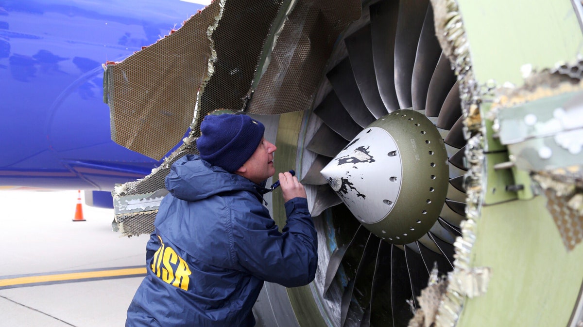 In new accounts released Wednesday, Nov. 14, into the April accident, the flight attendants described being unable to bring the woman back in the plane until two male passengers stepped in to help. (NTSB via AP, File)