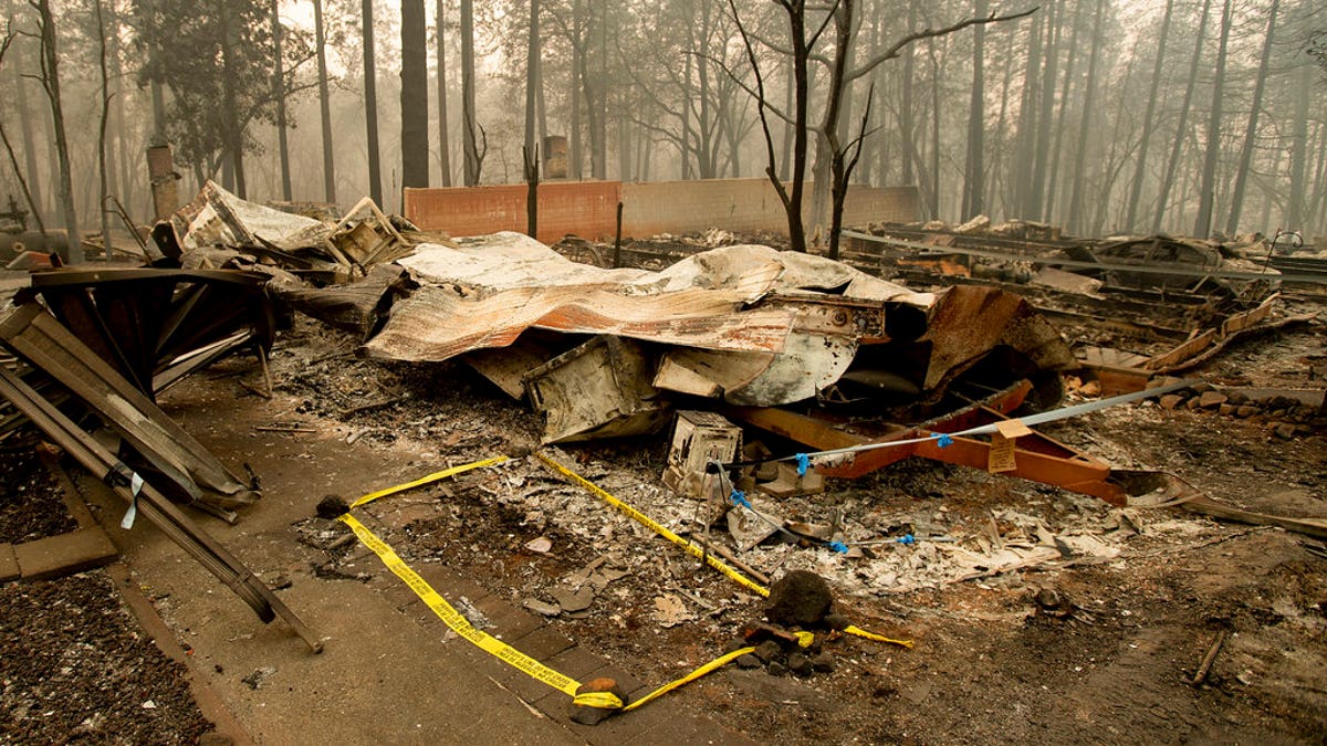 Tape marks a spot where sheriff's deputies recovered the body of a Camp Fire victim on Wednesday, Nov. 14, 2018, in Paradise, California.