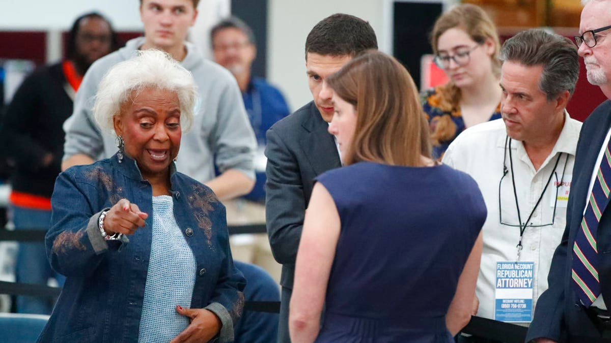 Broward County Supervisor of Elections Brenda Snipes, left, talks with political attorneys during a hand recount, Friday, Nov. 16, 2018, in Lauderhill, Fla.