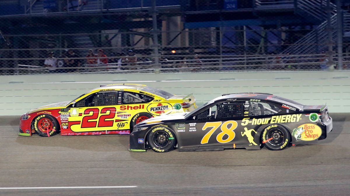 Joey Logano (22) and Martin Truex Jr. (78) drive on the track during the NASCAR Cup Series Championship auto race at the Homestead-Miami Speedway, Sunday, Nov. 18, 2018, in Homestead, Florida.