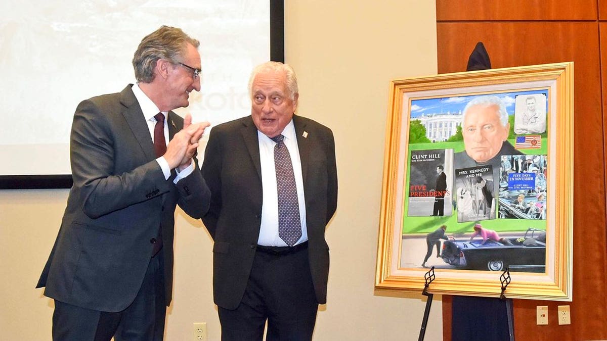 North Dakota Gov. Doug Burgum, left, talks with retired Secret Service agent Clint Hill at the Theodore Roosevelt Rough Rider award at a ceremony on Monday, Nov. 19, 2018, in Washburn, N.D. Gov. Burgum presented Hill with the portrait that will be displayed in the Rough Rider gallery in the state capitol in Bismarck. Hill is the 44th recipient of the state's highest honor.