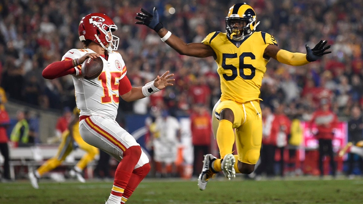 Kansas City Chiefs quarterback Patrick Mahomes, left, passes under pressure from Los Angeles Rams defensive end Dante Fowler (56) during the first half of an NFL football game Monday, Nov. 19, 2018, in Los Angeles.