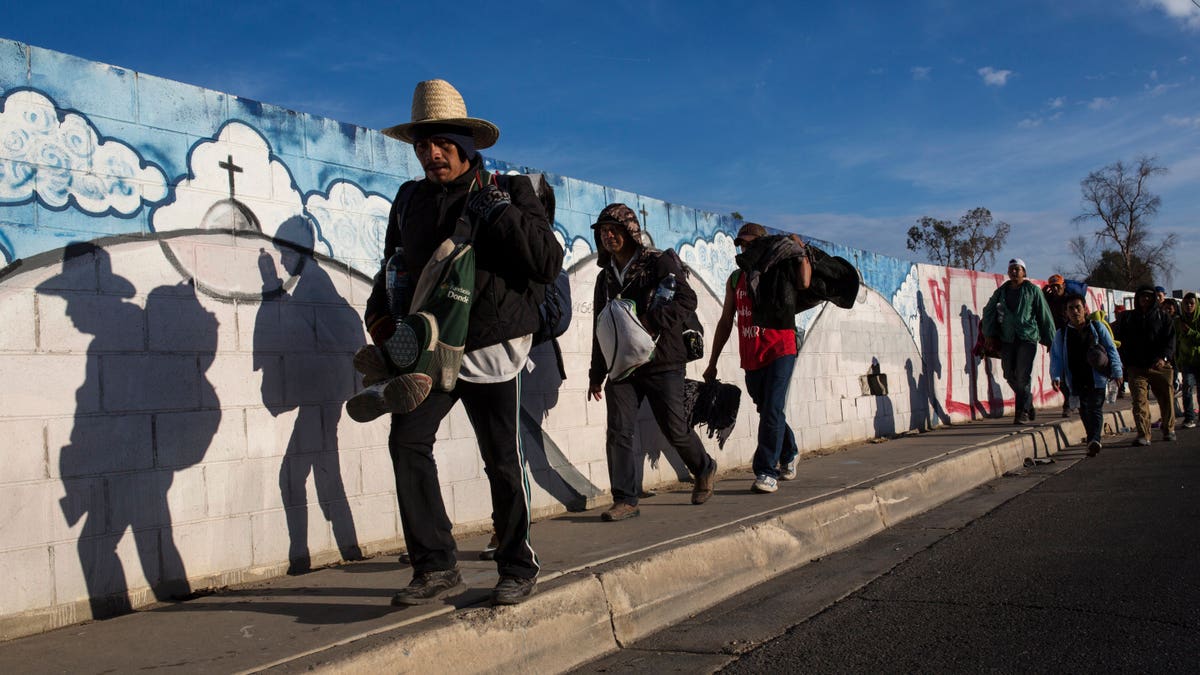 Migrants, who are part of a Central American migrant caravan, leave Mexicali for Tijuana, Mexico, Tuesday, Nov. 20, 2018. Tensions have built as nearly 3,000 migrants from the caravan poured into Tijuana in recent days after more than a month on the road.