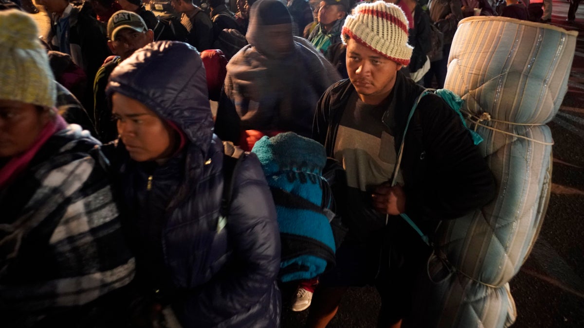 Central American migrants wait to access to the shelter in Tijuana, Mexico, Tuesday, Nov. 20, 2018. At least 3,000 migrants have arrived in Tijuana and the federal government estimates the number of migrants could grow to 10,000 in the coming weeks and months. (AP Photo/Ramon Espinosa)