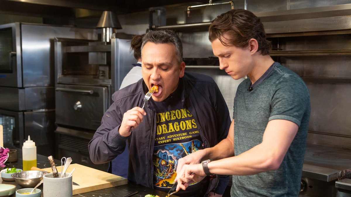 Director Joe Russo, left, and Tom Holland taste the Thanksgiving season dish prepared by chef Jessica Largey at an event at the Simone Restaurant in Los Angeles. Holland received a cooking lesson with “Avengers” co-director Russo and Largey who introduced him to kabocha squash, a delicacy known as Japanese pumpkin.