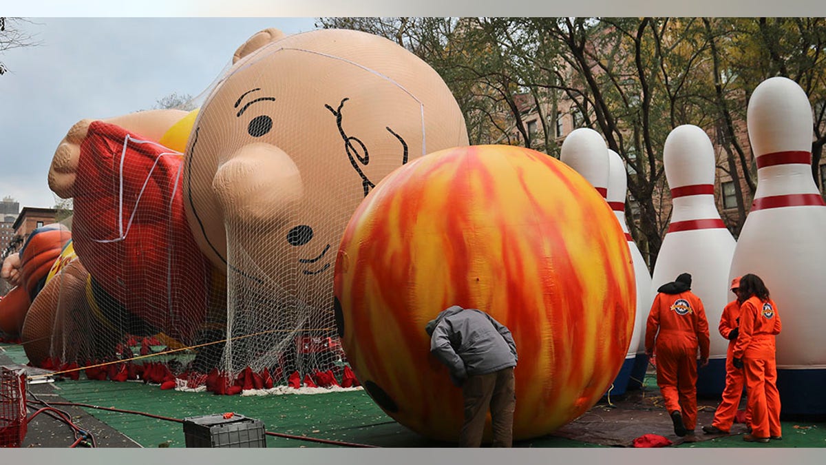 Giant character balloons, including Charlie Brown and Go Bowling, are inflated the night before their appearance in the 92nd Macy's Thanksgiving Day parade, Wednesday Nov. 21, 2018, in New York.