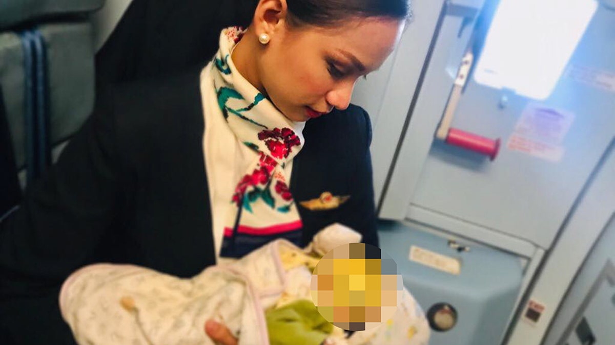 Patrisha Organo, 24, breastfeeding a strangers child during a flight.